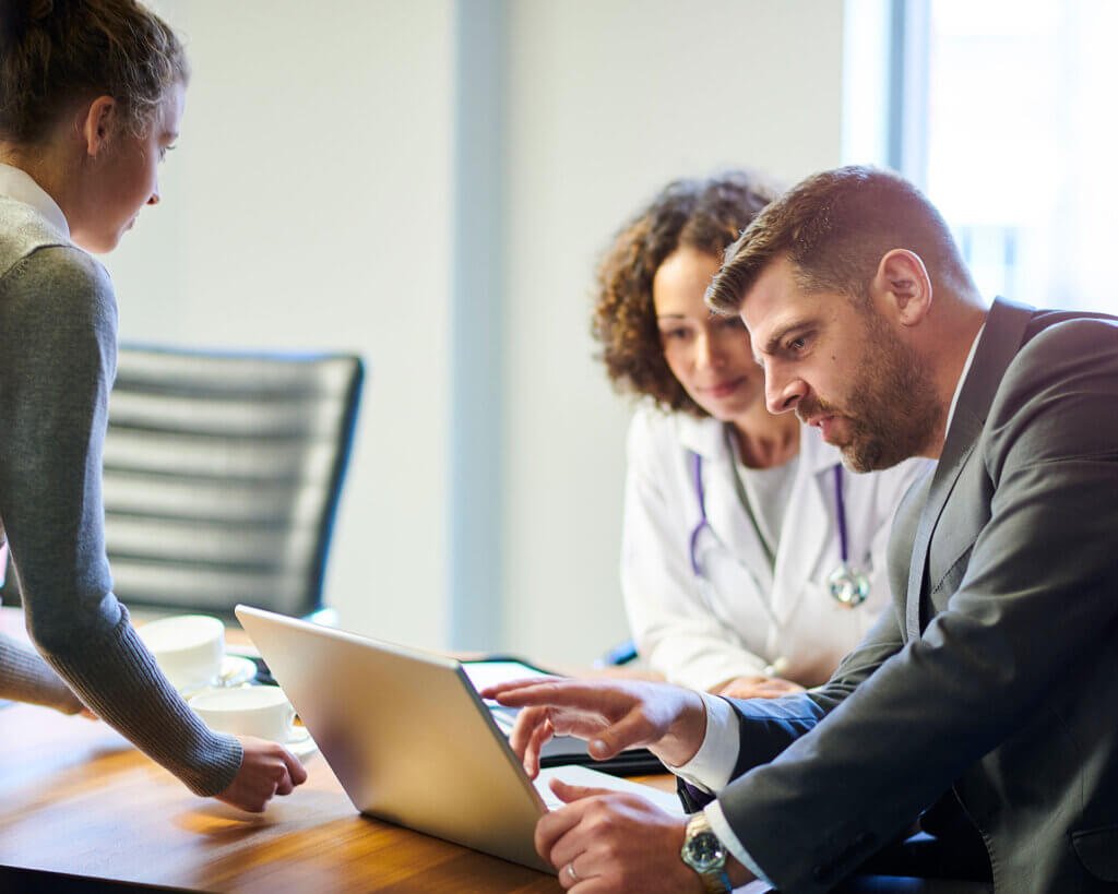 Healthcare Loan National Medical Funding doctor-businessman-in-hospital-looking-at-laptop-Healthcare Loan National Medical Funding