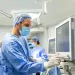 Doctor operating advanced medical equipment in a modern operating room