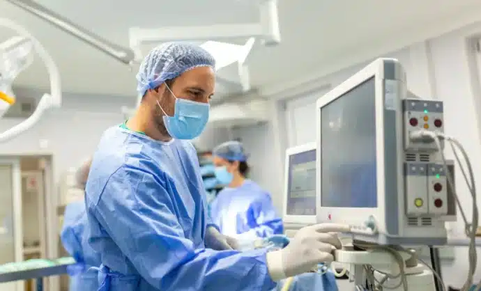 Doctor operating advanced medical equipment in a modern operating room