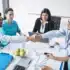 Healthcare professionals and financial advisors shaking hands during a meeting about medical facility loans and healthcare business financing solutions.
